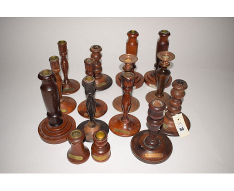 Fifteen turned wooden candlesticks, mainly teak, reclaimed from ships, to include: HMS Terrible, HMS Cornwall, HMS Birmingham