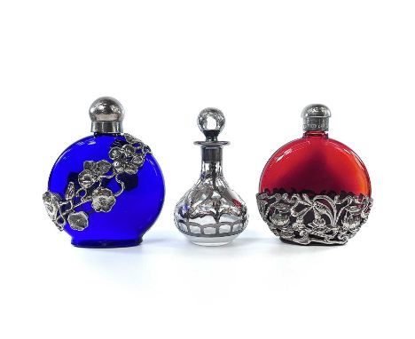 A sterling silver overlay glass scent bottle and stopper, height 9.5cm; together with a pair white metal mounted glass scent 