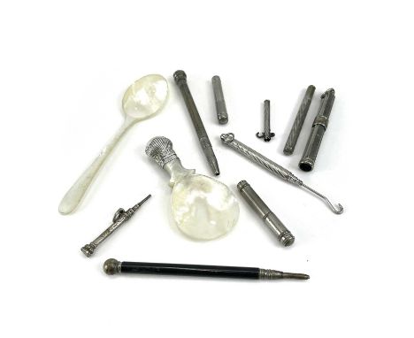 A collection of various propelling pencils, a button hook, two pencil lead holders, a mother of pearl caddy spoon with white 