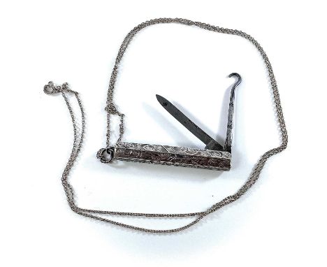 A sterling silver foliate engraved combination folding knife and button hook on a silver chain.