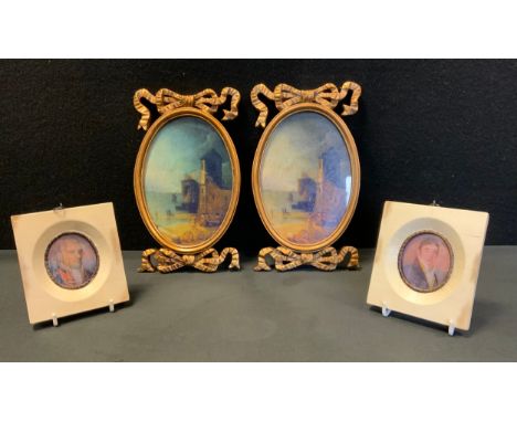 A pair of reproduction George III style portrait miniatures, as Gentlemen, white frames, 11cm high;  a pair of oval gilt fram