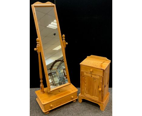 A pine cheval mirror, single drawer to base, 163cm high x 61cm wide x 36cm deep;  a pine bedside cabinet, quarter galleried b