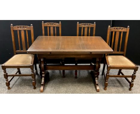 An Ercol oak draw-leaf trestle dining table, and set of four dining chairs, the table measuring 74cm high x 71cm x 114cm (ext