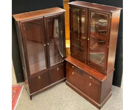 A Stagg Minstrel two door display cabinet, 3/4 length glazed doors over pair of cupboard doors, 181cm high, 96cm wide, 37.5cm