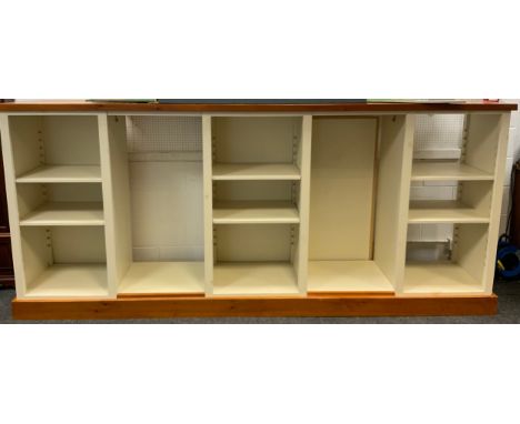 A shop fitting display unit,  pine top and plinth, with five shelf or hanging rail compartments, hook to one end, 134cm high,