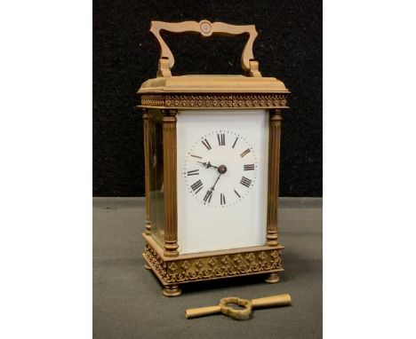 An early 20th century carriage clock, ornate banded case, white dial, bold Roman numerals, 16cm high 