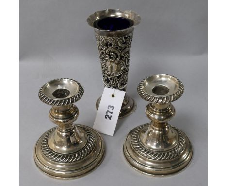 A Victorian silver trumpet-shaped vase with blue glass liner, a pair of silver dwarf pillar candlesticks 