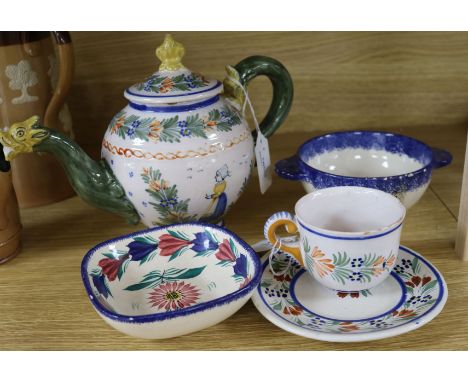 A Quimper teapot with dragon spout, a cup and saucer and two later bowls
