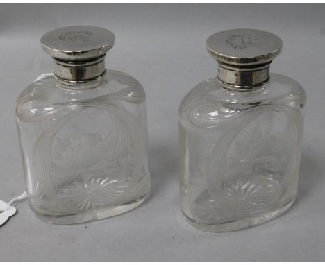 A pair of Edwardian Art Nouveau silver mounted glass scent bottles with stylised decoration, Drew & Sons, London, 1903, 3.75i