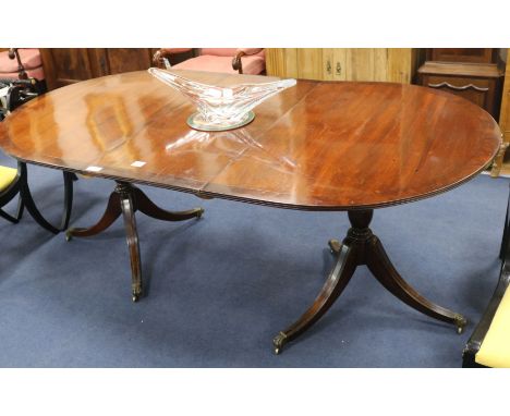 A Regency style mahogany twin pillar dining table, with one leaf, W.107cm