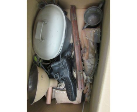 A box of miscellaneous including bygone ice skates, hand-held lamp, boots, etc