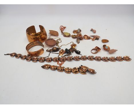 A box of copper coloured jewellery including bangle, brooches, earrings etc