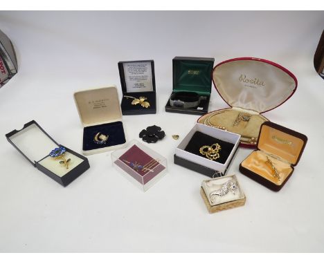 A quantity of costume jewellery including brooches and lady's Rotary watch