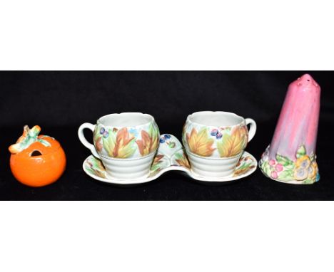 A CLARICE CLIFF NEWPORT POTTERY PAIR OF MUGS ON STAND  decorated in the 'Celtic Leaf and Berry' pattern, the mugs stamped 42A