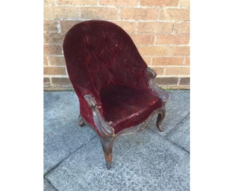 A MAHOGANY FRAMED CHILD'S BUTTON BACK ARMCHAIR  upholstered in a dark red fabric and raised on cabriole legs, H 57cm