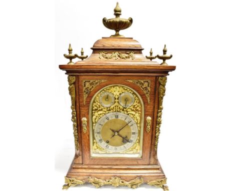 A LARGE EDWARDIAN GILT METAL OAK BRACKET CLOCK WITH BRACKET  the 8-day (unsigned) movement striking on two coiled gongs, the 
