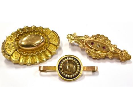 MEMORIAL BROOCHES  three late 19th century to early 20th century brooches comprising a small 9ct gold bar brooch with a centr