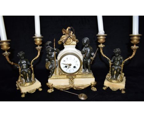 A 19TH CENTURY FRENCH CLOCK GARNITURE  the gilt metal mounted clock with twin cherubs, enamel dial with Arabic numerals and f