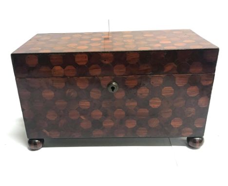 A 19TH PARQUETRY INLAID TEA CADDY,  having a circular metal escutcheon, the interior with a central compartment for the glass