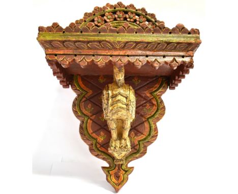 A CARVED AND PAINTED CLOCK BRACKET  with floral carved and painted decoration, the surface for the clock measuring, W 27cm x 