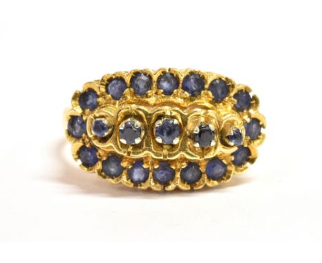 AN 18CT GOLD SAPPHIRE CLUSTER RING The boat shaped cluster head set with 21 small sapphires with the cluster measuring 2cm lo