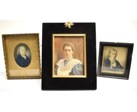 THREE PORTRAIT MINIATURES:  an Edwardian watercolour on ivorine of a lady in ebonised easel back frame 18cm x 14cm ovreall; a