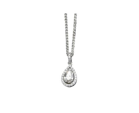 A diamond pendant, the central pear-shaped diamond weighs approximately 0.64cts and is set within a surround of circular-cut 