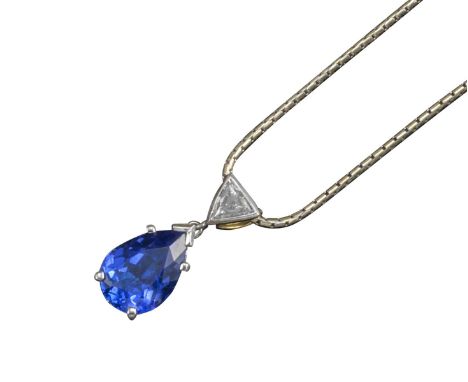 A tanzanite and diamond pendant, the pear-shaped tanzanite set in pierced mount suspends from a triangular-shaped rubover-set