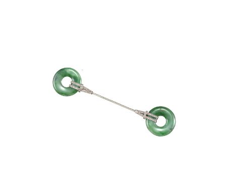 An Art Deco French jade and diamond jabot pin, each terminal mounted with a jade disc with rose-cut diamond-set clips in plat