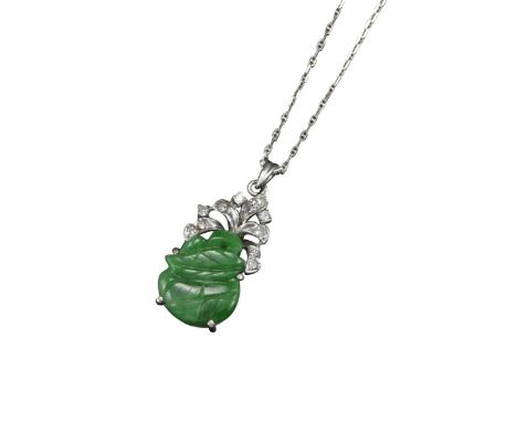 A jade and diamond pendant, the carved jade plaque set beneath diamond-set scrolls in white gold, on fine-link white gold nec