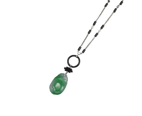 An Art Deco style jade, black onyx and diamond pendant, the foliate carved jade pendant suspends from three cylindrical links