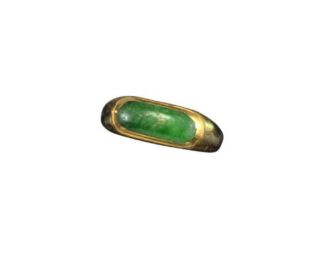 A jade-mounted yellow gold ring, the oval jade plaque rubover-set within yellow gold mount, size N