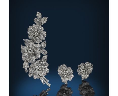 An impressive diamond-set foliate corsage and matching earrings, naturalistically formed as wild roses, set overall with grad