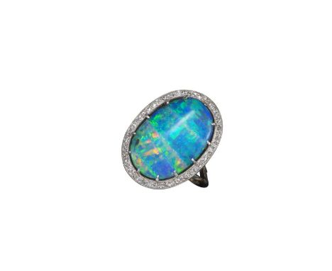 A boulder opal and diamond cluster ring, the oval-shaped boulder opal set within a surround of circular-cut diamonds in plati