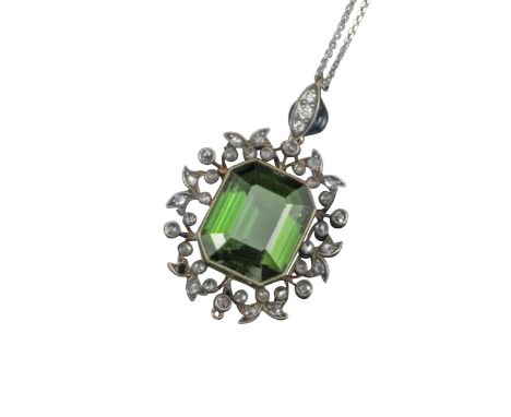 A 19th-century tourmaline and diamond pendant, the emerald-cut green tourmaline set within a foliate diamond-set border in si