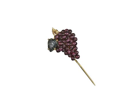 A fruiting vine gold stick pin, the grapes formed from garnet beads, with a green-stone leaf, set in yellow gold, stamped ESC