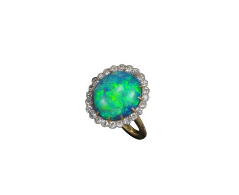 An opal and diamond cluster ring, the solid cabochon black opal claw-set within a single-cut diamond border, millegrain-set i