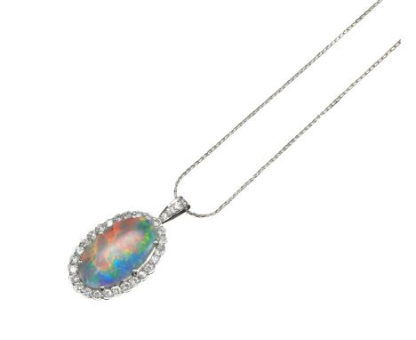 An opal and diamond pendant, the solid cabochon opal set within a surround of circular-cut diamonds in white gold, on a fine-