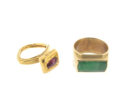 A ruby-mounted gold ring, the pear-shaped ruby cabochon set in a medieval style mount, approx. size J, with a jade-mounted go
