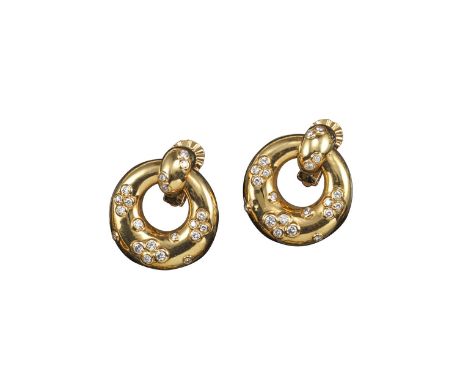 A pair of diamond and gold ear clips by Cartier, of polished door-knocker design accented by rubover-set circular-cut diamond