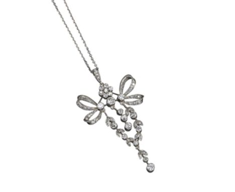 A Belle Époque diamond pendant, designed with foliate swags and bows, millegrain-set overall with graduated circular-cut diam