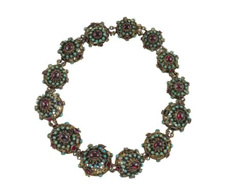 A gem-set silver necklace, each bombé link set with a cabochon garnet within a surround of turquoise cabochons, faceted garne