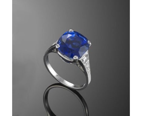 A sapphire and diamond ring, the cushion-shaped sapphire weighs 7.95cts, each shoulder set with two tapered baguette-shaped a