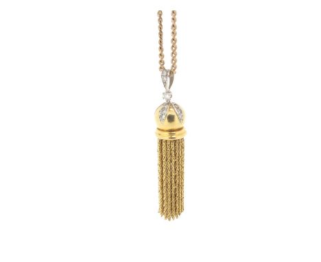 A gold tassel pendant, the spherical upper section decorated with diamond-set lozenges and suspends articulated gold tassels,