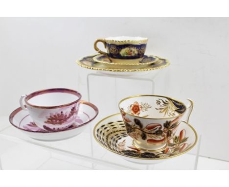 A ROYAL WORCESTER BONE CHINA TRIO, blush ivory ground with floral painted cobalt blue banding, comprising tea plate, cup and 