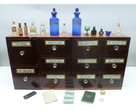 A 19TH CENTURY STAINED WOOD APOTHECARY CABINET, fitted eleven drawers each with a glass name plate and glass handles, name in