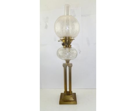 AN EDWARDIAN OIL LAMP, the brass Corinthian cluster column stem on square platform base, with cut glass reservoir, etched cle