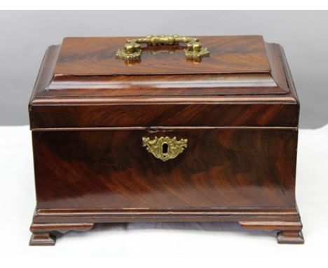 AN 18TH CENTURY MAHOGANY TEA CADDY, the hinged cover with decorative brass handle, re-fitted interior, raised on ogee bracket