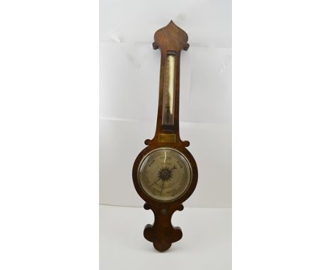 A 19TH CENTURY WALNUT VENEER WHEEL BAROMETER with thermometer, the silvered dial engraved "J.Kaiser, 131, Earls Court Rd S.W.
