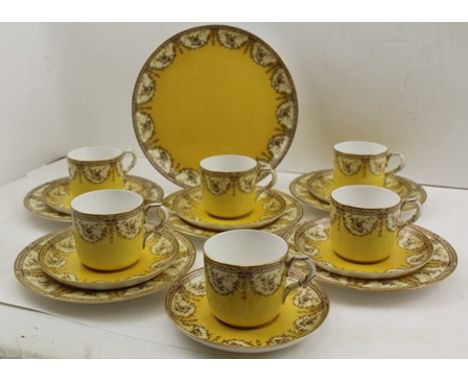  A ROYAL WORCESTER PART PORCELAIN TEA SET, yellow ground with floral swags, comprising serving plate, five tea plates, six sa